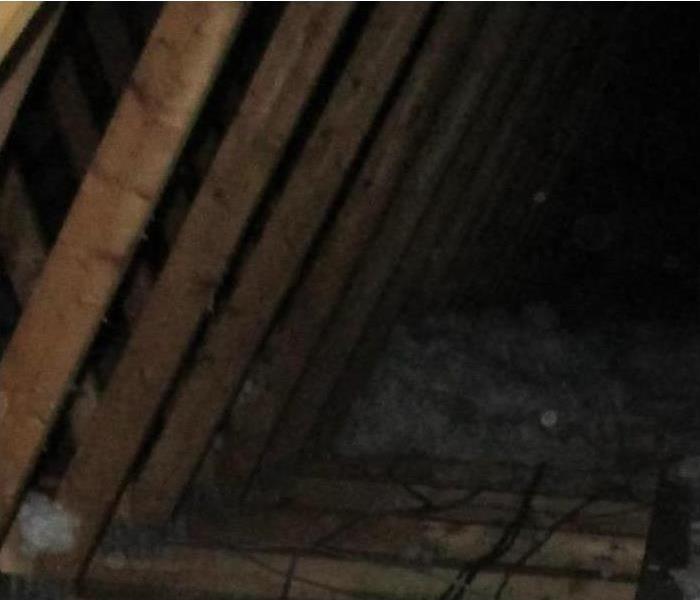 A picture of an attic full of wet insulation. 