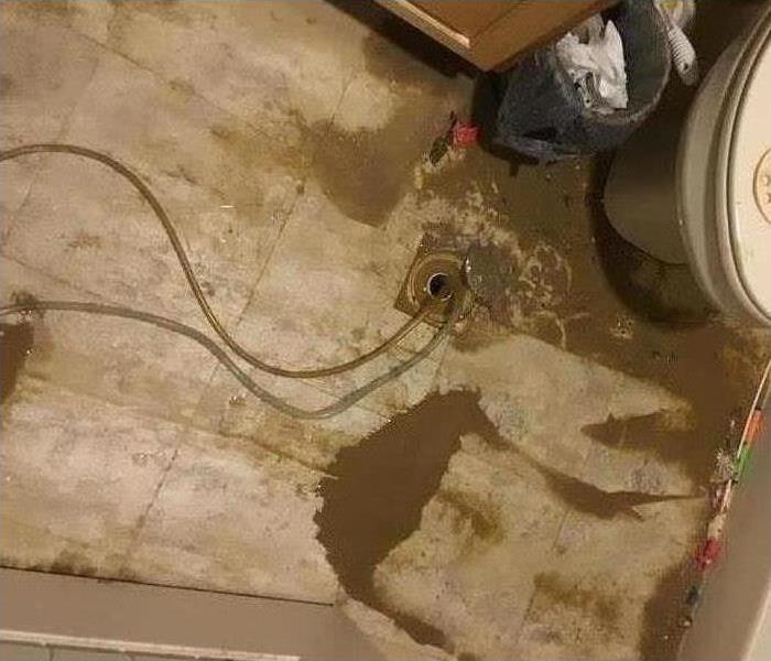 A picture of water and mud all over the floor from the water damage.