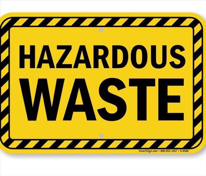 A picture of a sign of Hazardous waste that is yellow and black.
