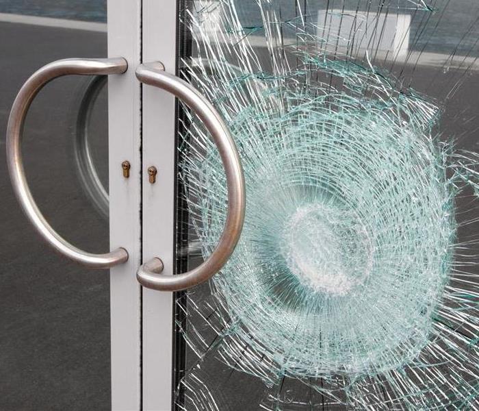 A picture of a broken glass business door 