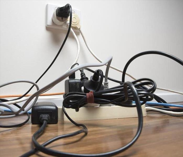 A picture of am Extension Cord being misused with multiple cord plugged into one. 